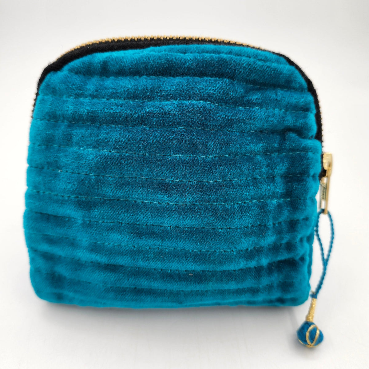 Velvet pouch in blue, one of four colourways, with a block print lining and two internal pockets.