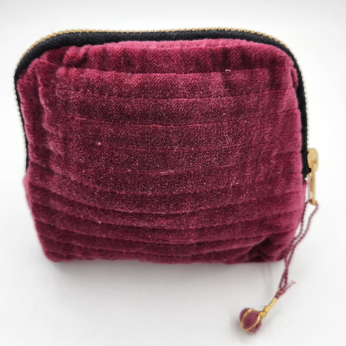 Velvet pouch in ruby, with a block print lining and two internal pockets for jewellery and accessories.