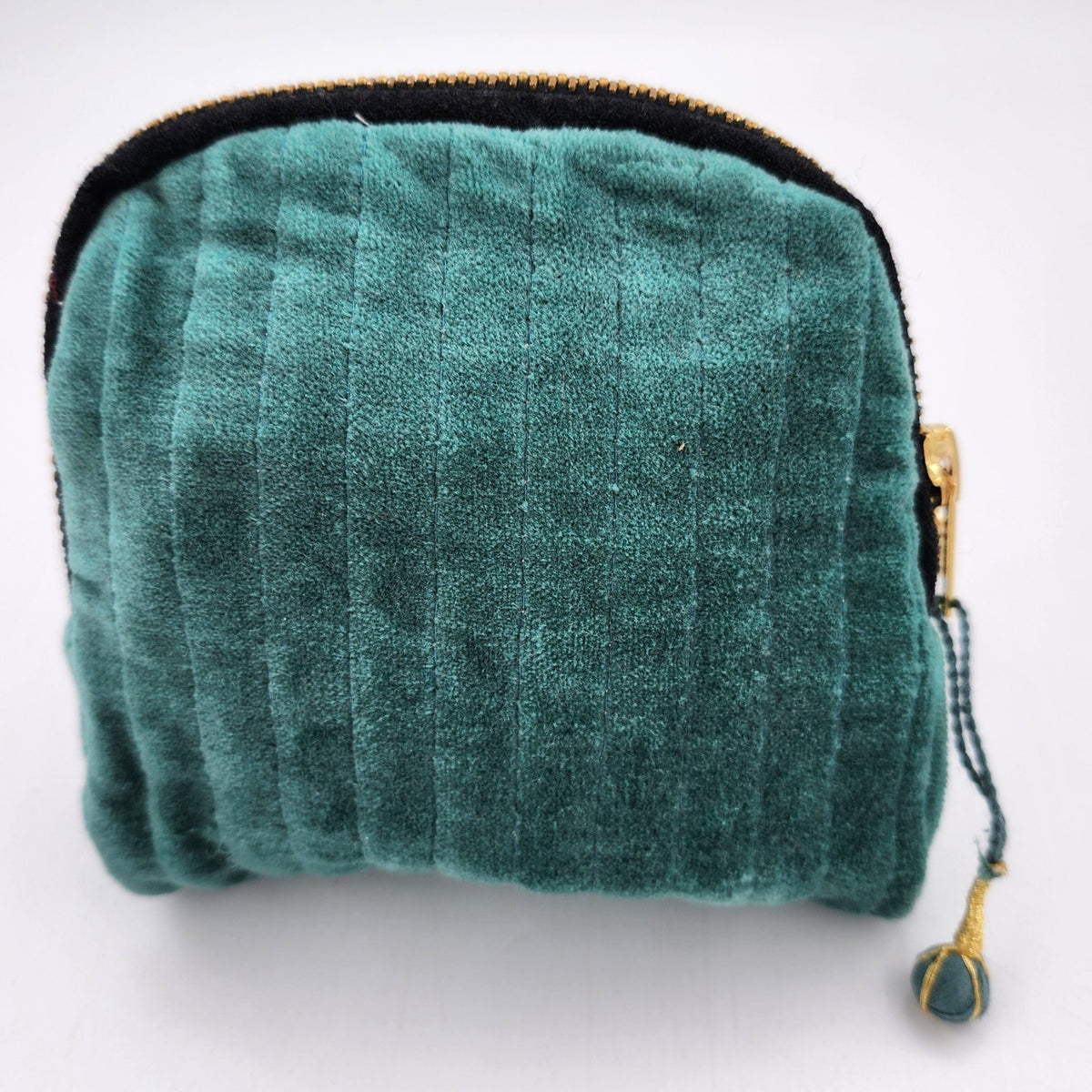 Velvet pouch in teal, a brass zip closure and block print lining, sized 5 inches wide by 5 inches high.