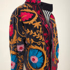 Black velvet jacket with hand-worked suzani stitching, striped cotton lining