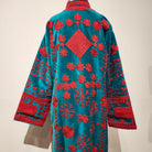 Turquoise velvet coat with cerise suzani stitching, striped cotton lining