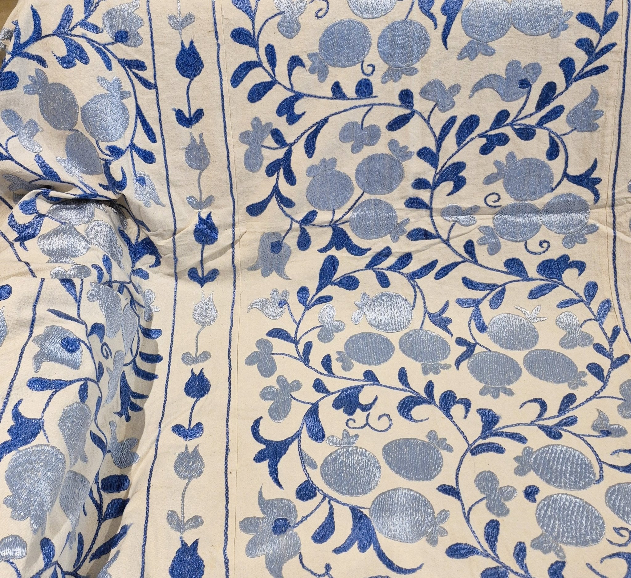 Suzani with blue pomegranate and leaf pattern on cream background