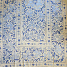 Decorative  hand embroidered suzani fabric with blue pomegranate pattern on a cream background