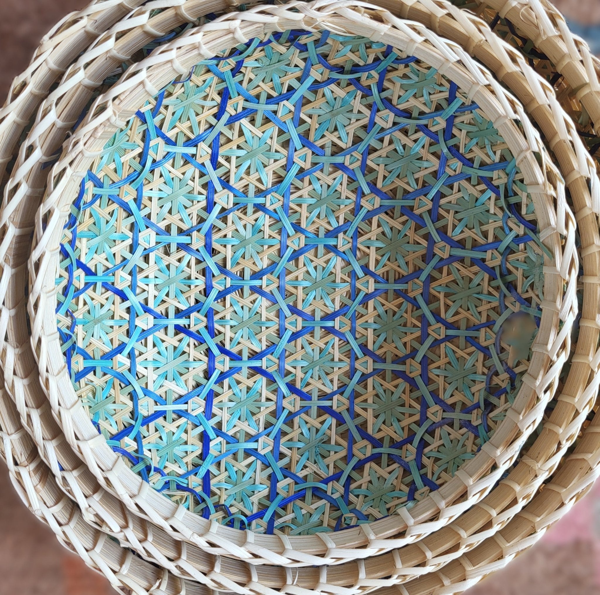 Round woven wicker basket with turquoise and blue mosaic interior, handcrafted storage