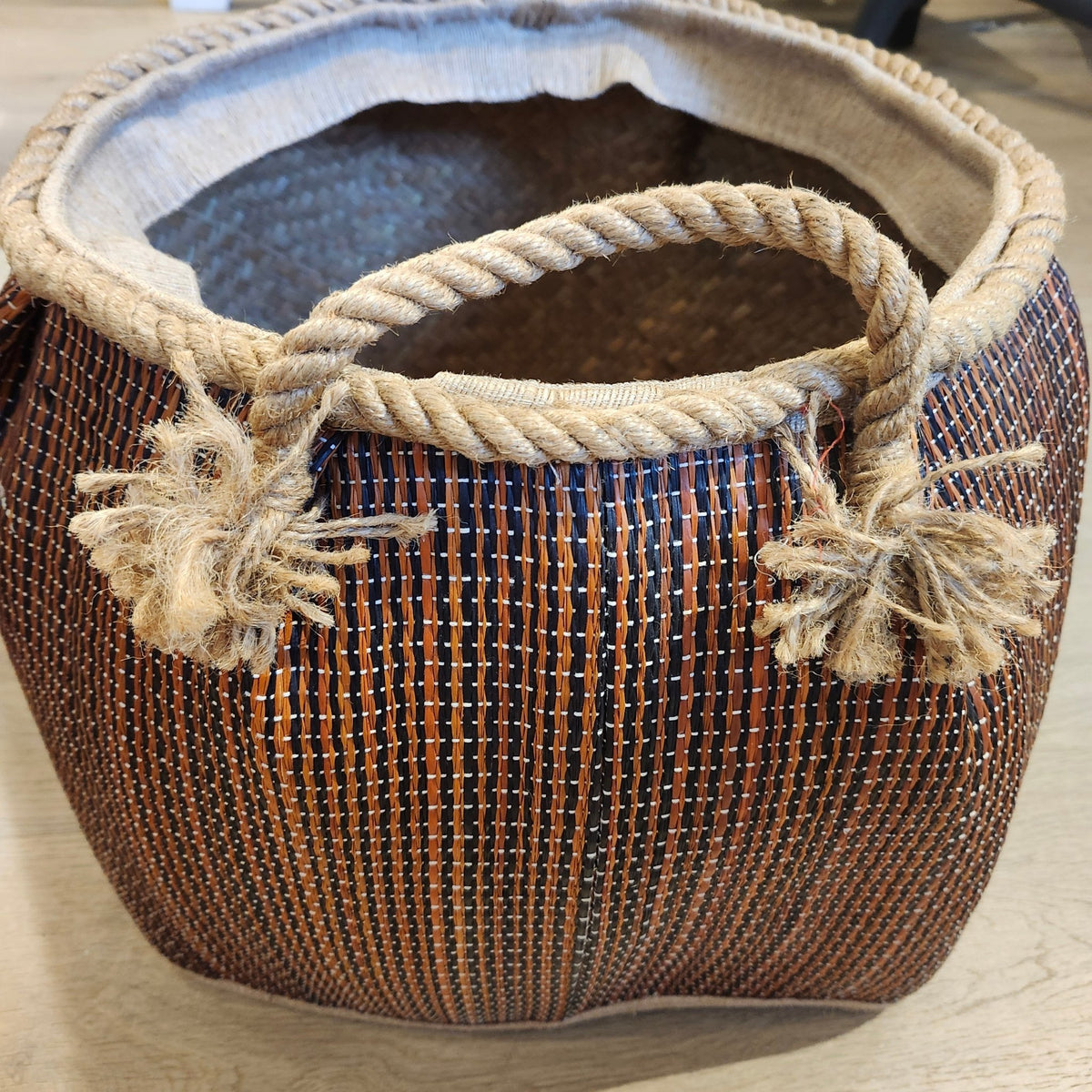 Large wicker basket with a dark stripe and rope handles, 35cm in diameter, handcrafted from lightweight wicker