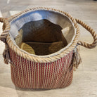 Pink wicker basket with a dark stripe and rope handles, 28cm high and 27cm in diameter, handcrafted and lightweight