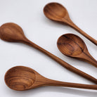 Teak wooden jam spoon with curved handle, detail
