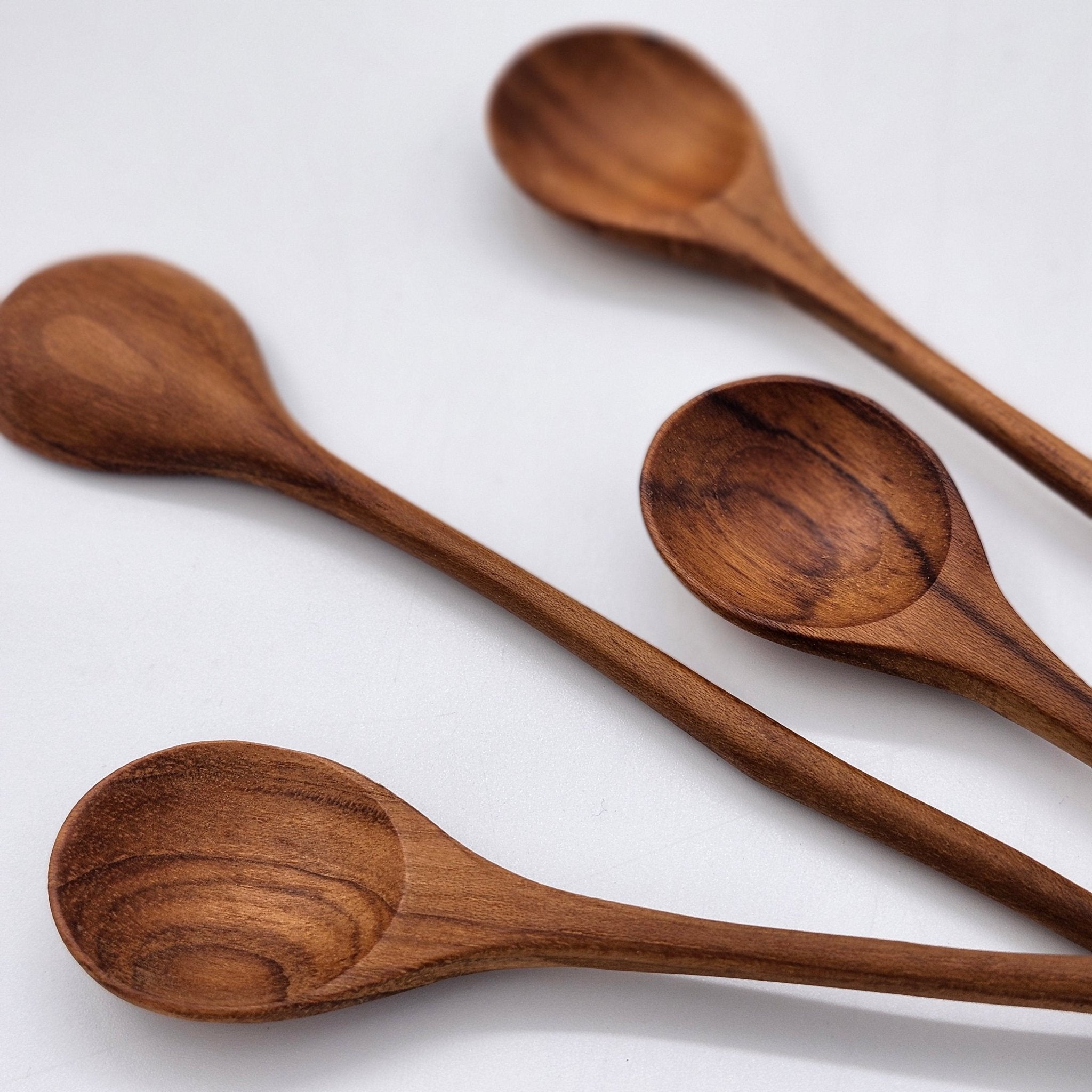 Teak wooden jam spoon with curved handle, detail