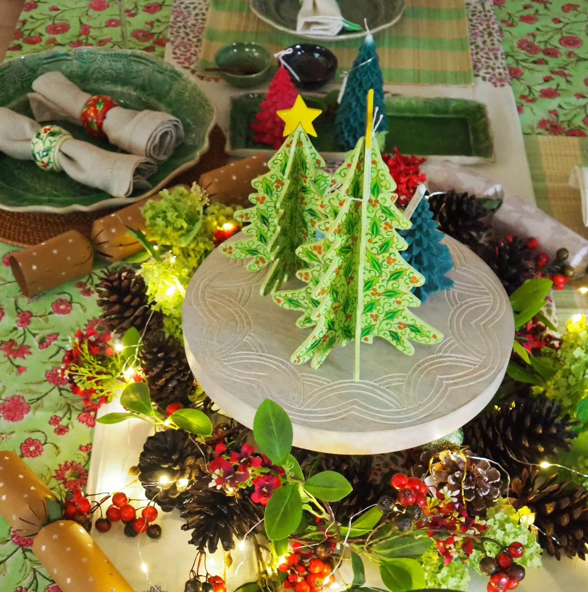 Papier-mache Christmas tree table decoration with a holly pattern
