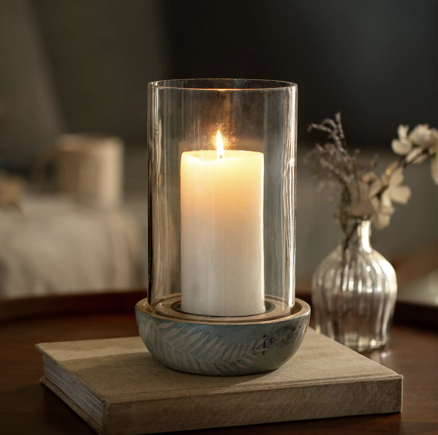 Aamay glass hurricane candle holder with an enamel base hand-painted with botanical motifs