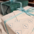 Inside gift wrapping in white, red and green with ribbon