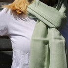 Plain pashmina shawl, soft and lightweight, styled around the neck