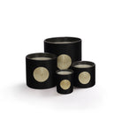 Sabra Dana Oud candle, black silk-wrapped jar, styled view