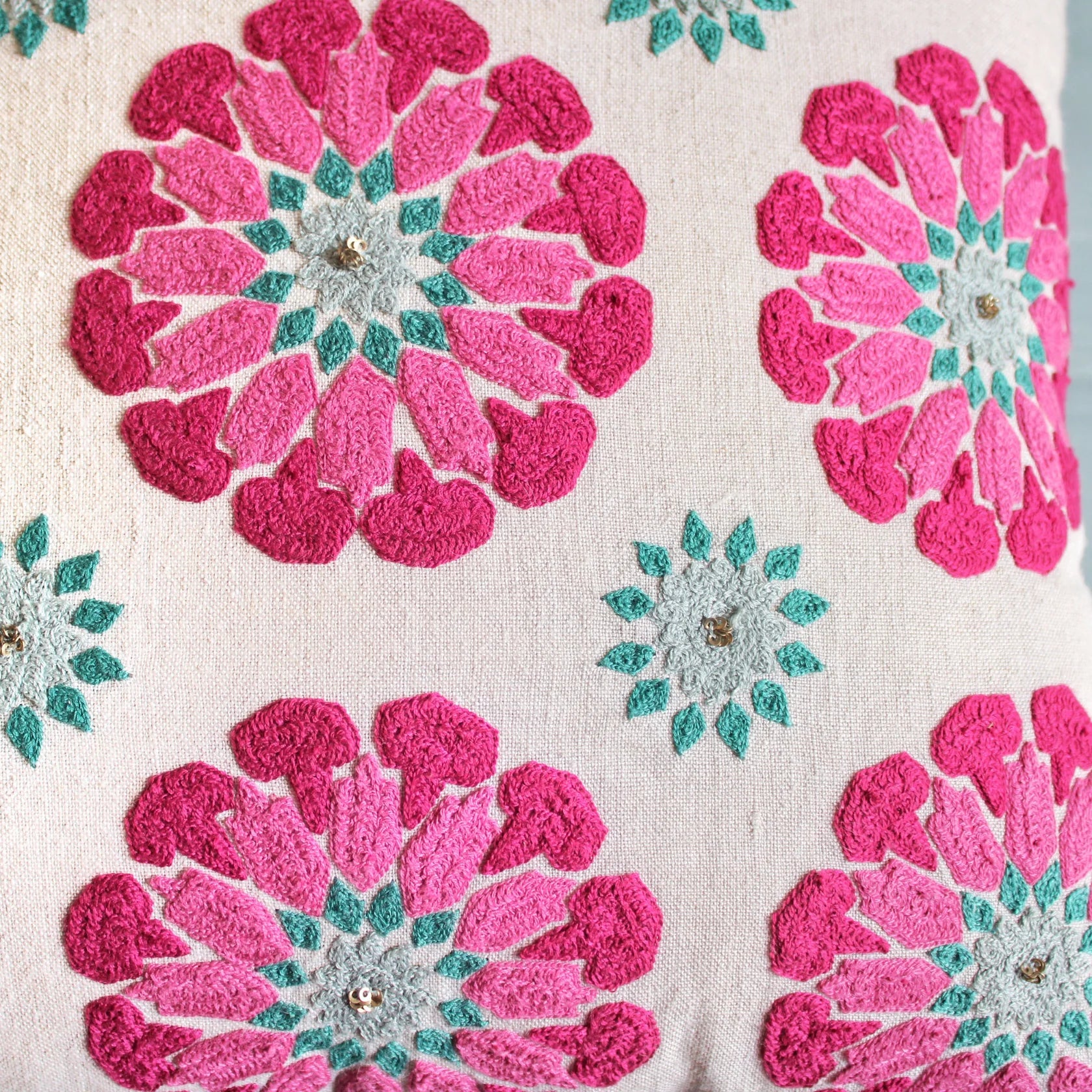Suzani Butah Motif linen cushion, pink and turquoise needlework