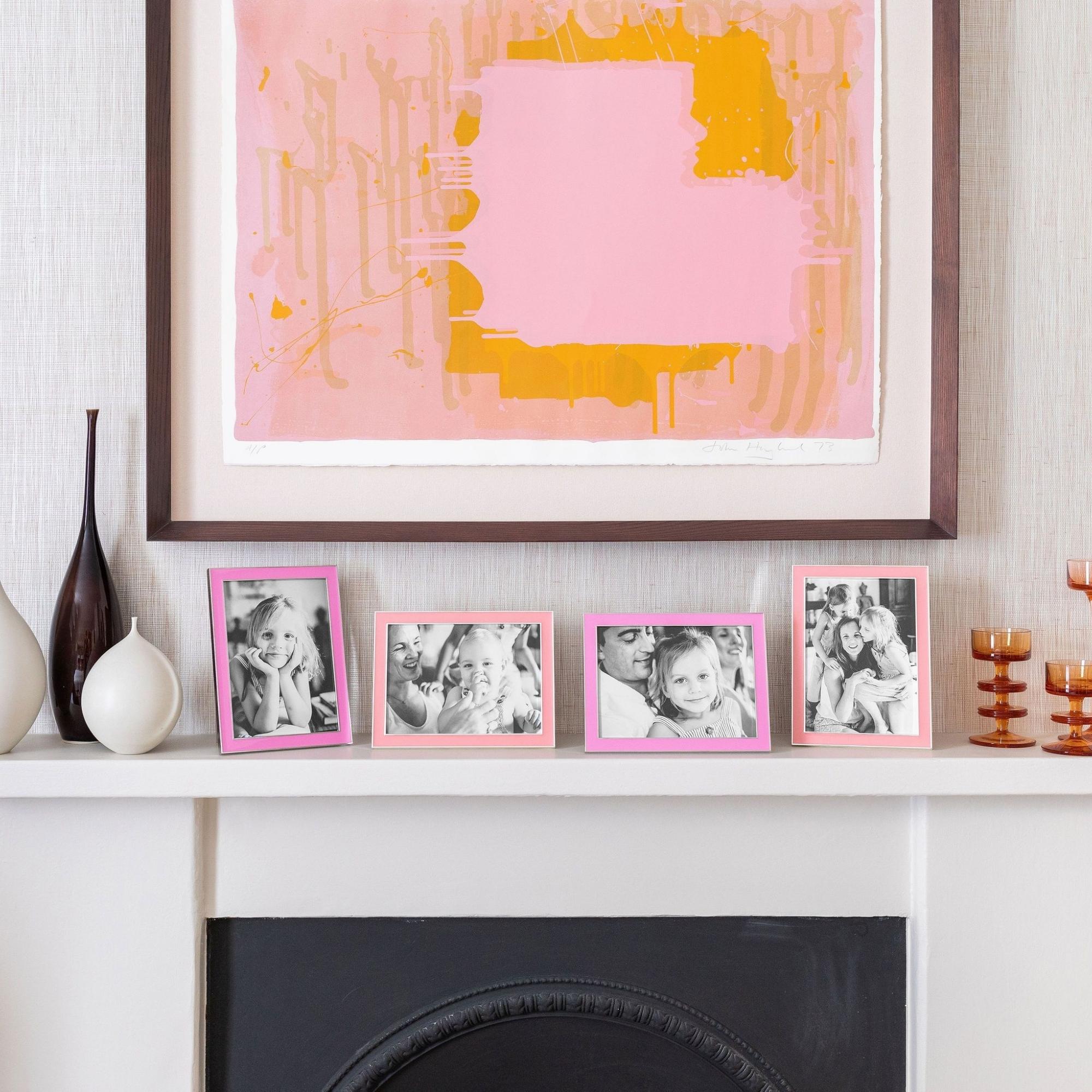 Electric pink enamel frame by Addison Ross, styled in a home setting