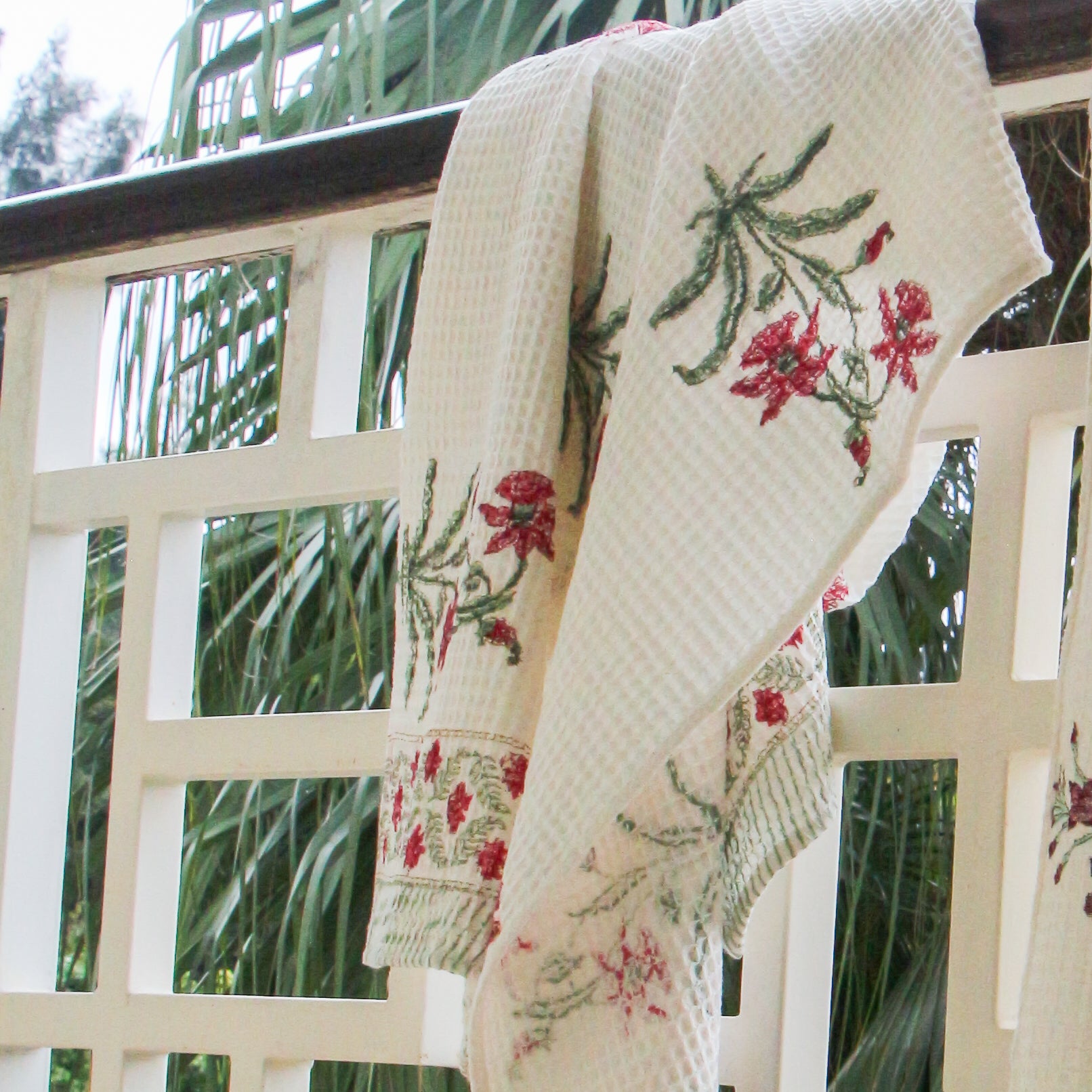 Block Print Waffle Towel hanging over a balcony with palm tree