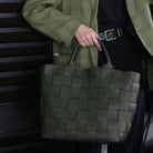 Braided shopper bag in green vegan leather with a decorative braid