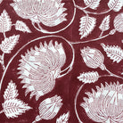 Burgundy lotus block-print cotton tablecloth with floral motifs and neatly striped edges