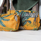Safari block-print wash bag in mustard with animals and palms