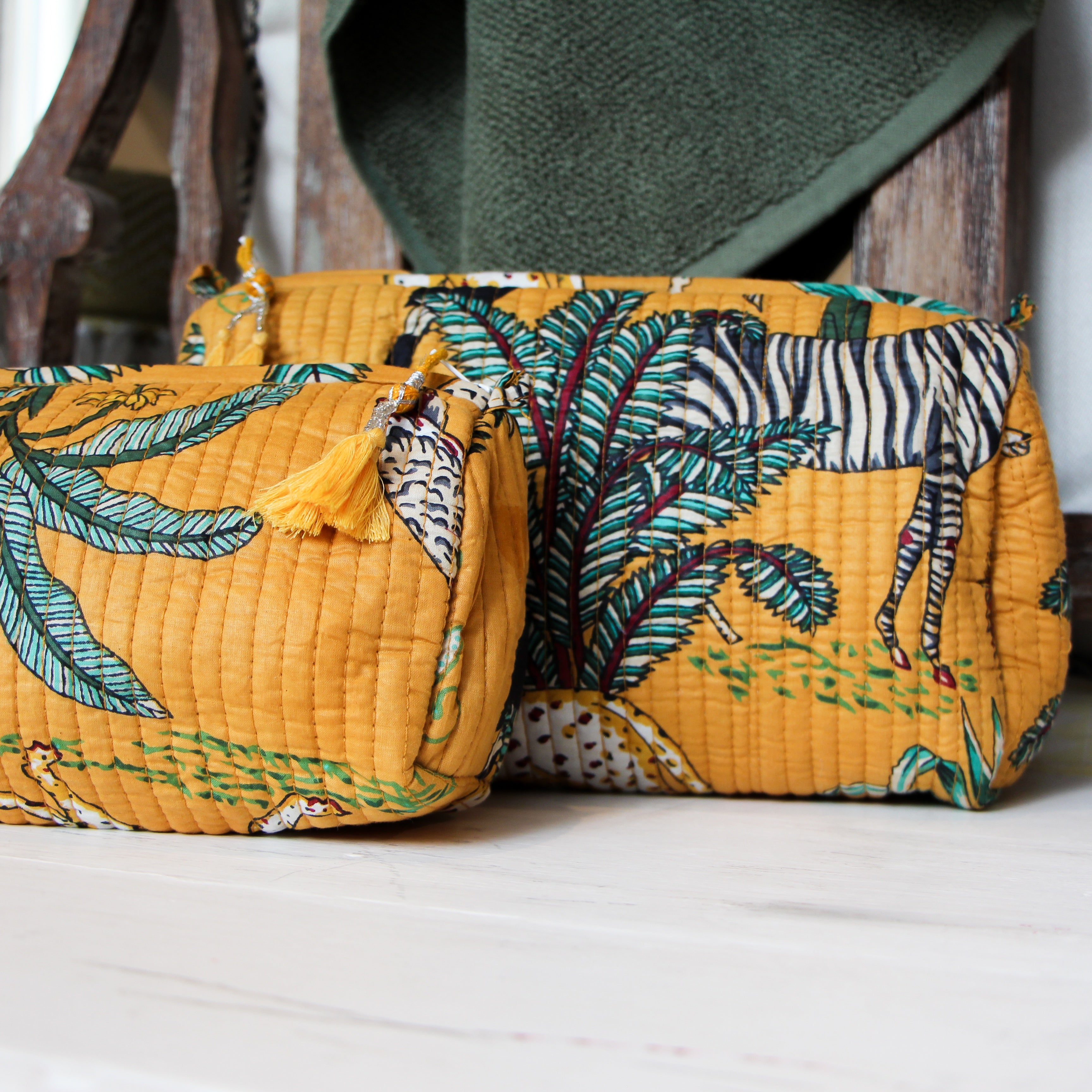 Safari block-print wash bag in mustard with animals and palms