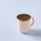 Blush striped ceramic mug with a wooden lid