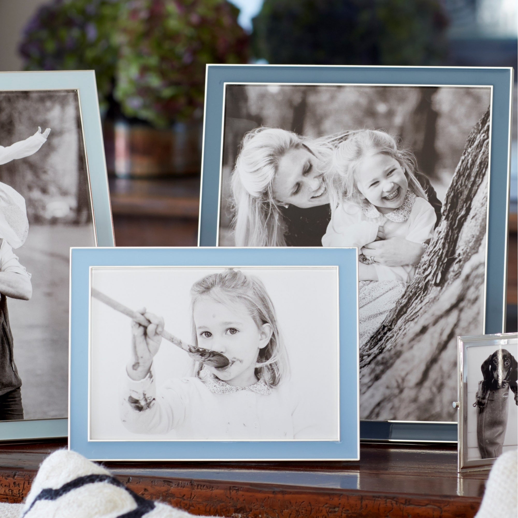 Periwinkle enamel frame by Addison Ross, styled with a photo in portrait orientation