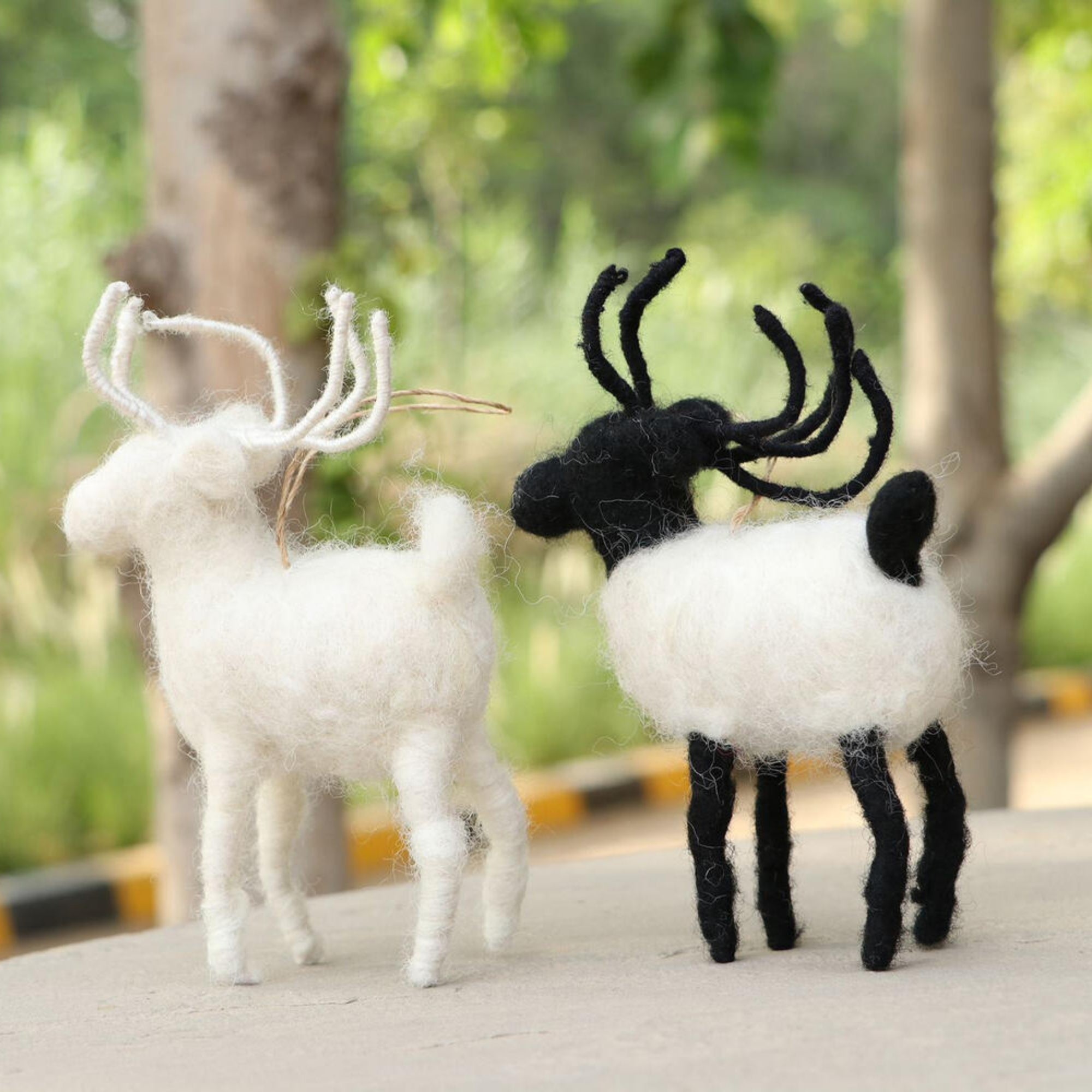 Hand-stitched felt reindeers, black and white, detail