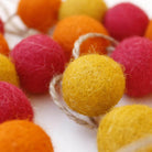 Felt pom-pom garland in warm tones, handwoven, India, detail