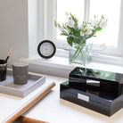 Black lacquer watch box lined in cream suede with silver fittings