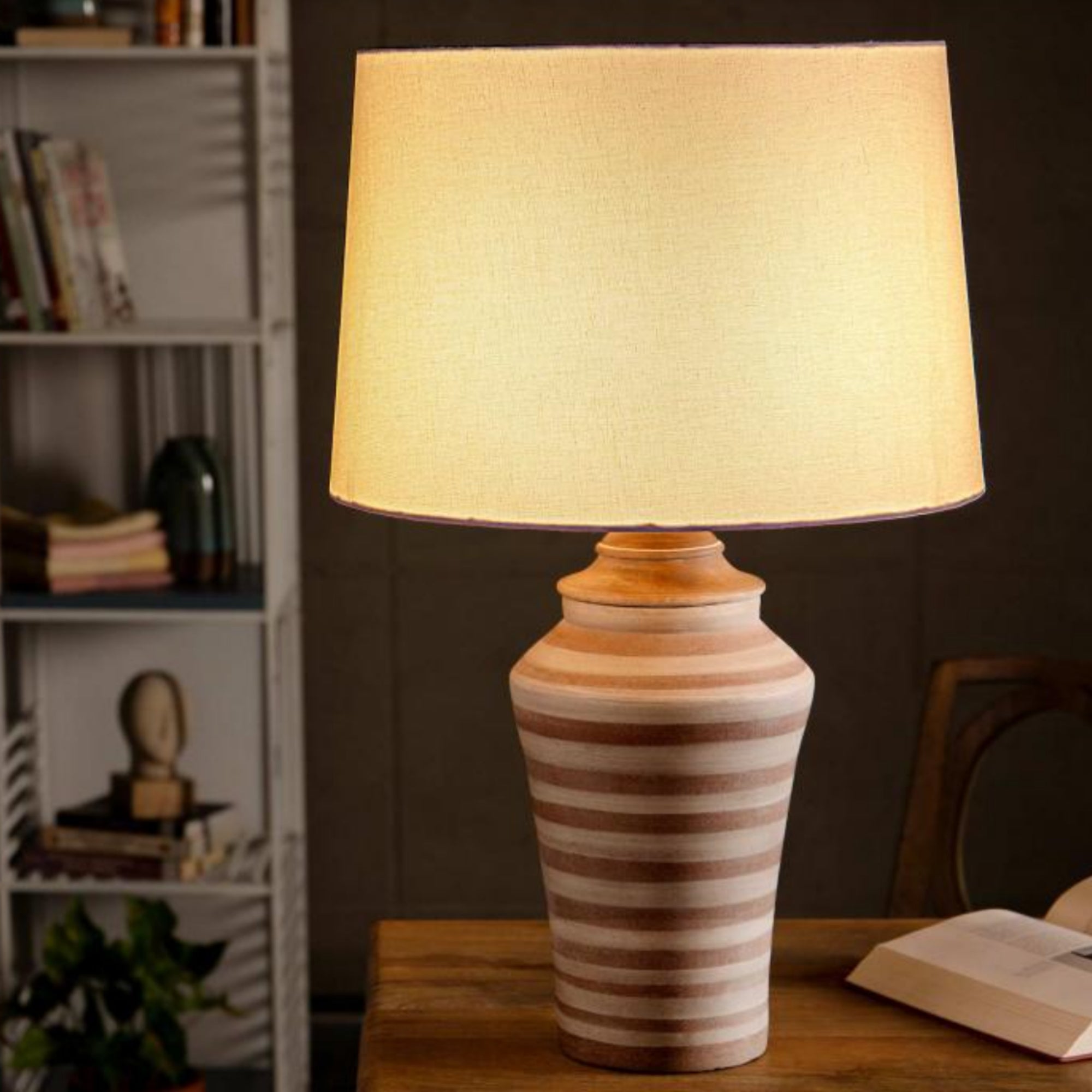 Terracotta table lamp with white cotton lampshade, styled