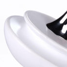 Tip-Top white spinning top, wood and stainless steel, side view