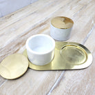White marble condiment set, two jars with brass lids on brass tray